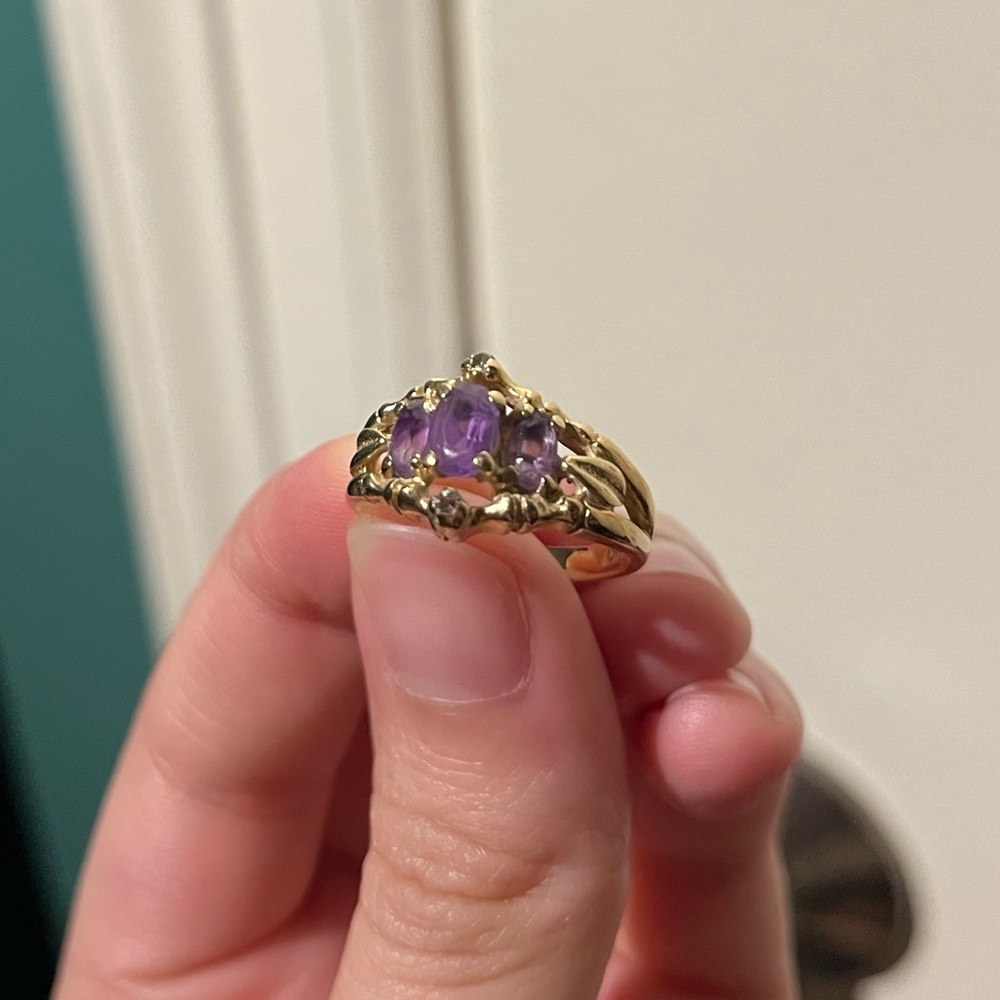 Gold ring with purple stones